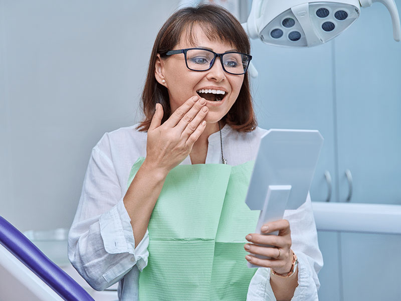 Dentist explaining differences between fillings and crowns